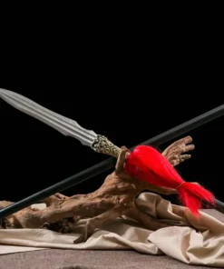 A Qiang Chinese spear weapon displayed next to its handle-extension, leaning against a small wood log.