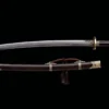A Chinese Dao weapon, displayed next to its decorative scabbard.