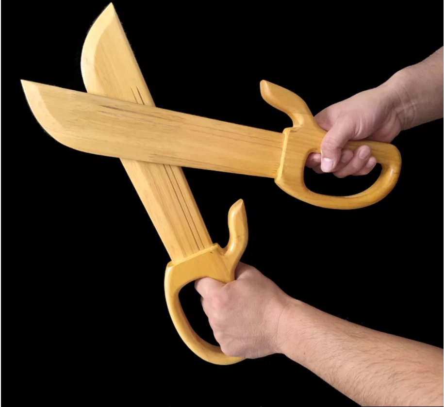 Martial Arts Training Knives Two hands shown holding a pair of bamboo martial arts training knives.