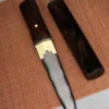 A mini Tanto knife presented in Shirasaya, displayed next to its wooden sheath, lying on a bamboo mat.