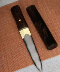 A mini Tanto knife presented in Shirasaya, displayed next to its wooden sheath, lying on a bamboo mat.