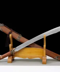 A niuweidao sword and its scabbard, displayed leaning against a small wooden stand.