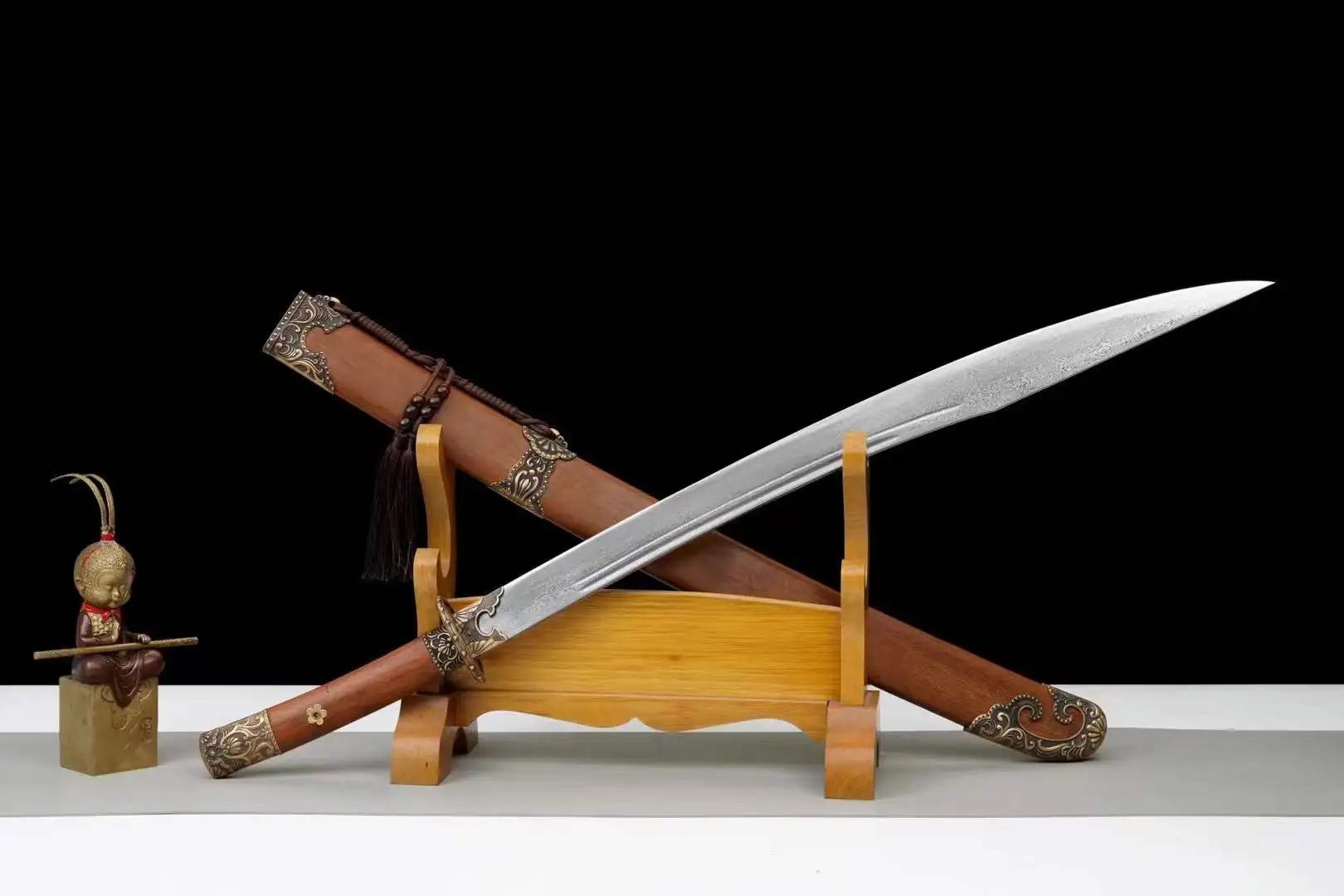 Niuweidao Sword A niuweidao sword and its scabbard, displayed leaning against a small wooden stand.