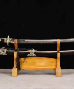 A Qing Dao sword saber, displayed next to its decorative scabbard, on a small wooden stand.