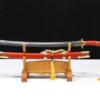 A traditional Chinese sword Dao, displayed next to its scabbard, on a wooden stand.