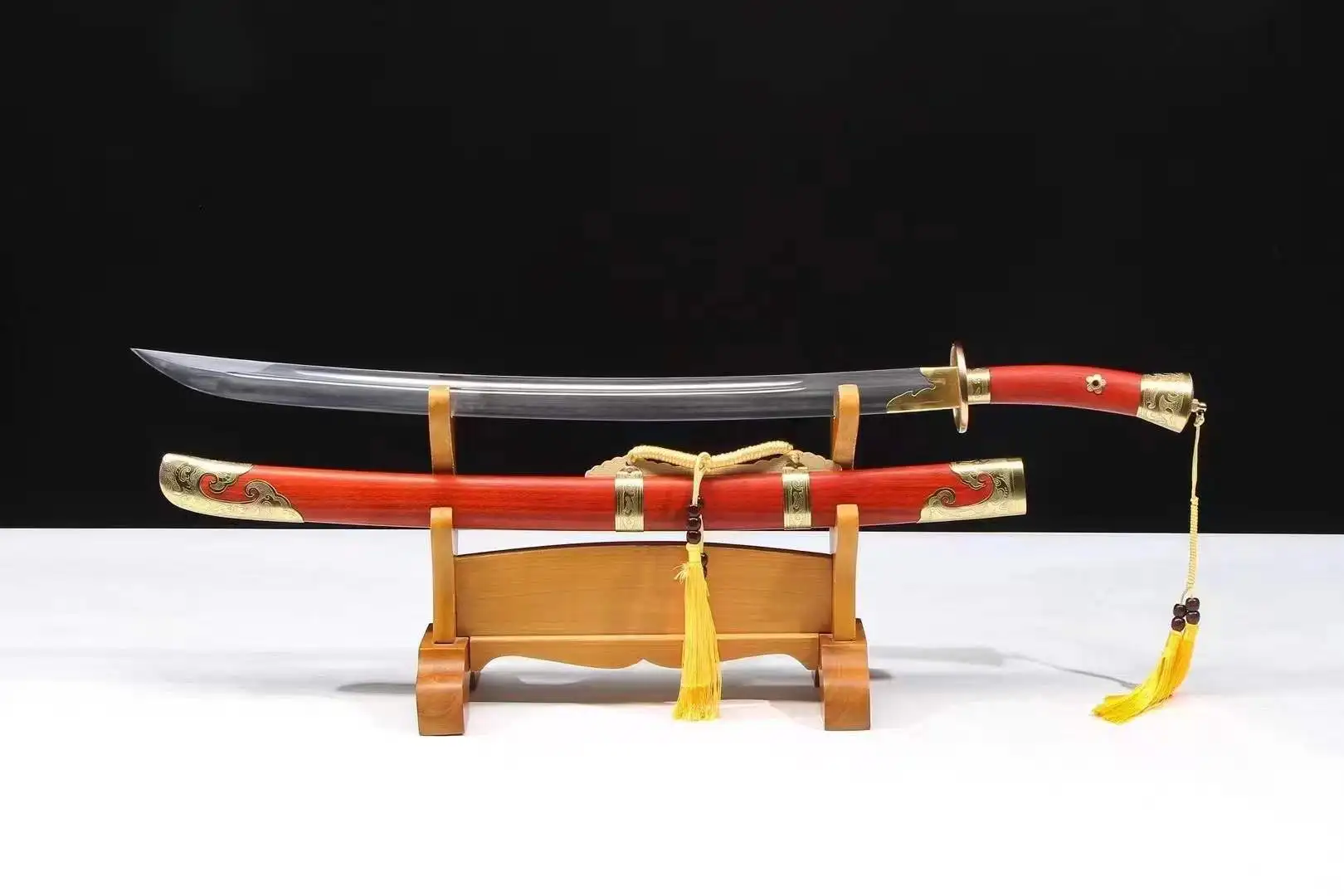 Traditional Chinese Sword A traditional Chinese sword Dao, displayed next to its scabbard, on a wooden stand.