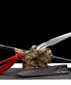 A Qiang spear weapon displayed next to its pole handle extension, leaning against a small wood log.