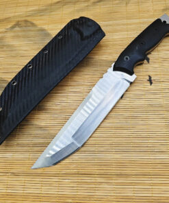 The best combat knife displayed next to its Kydex sheath, on rattan matting.