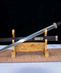 A Han Jian sword displayed next to its traditional scabbard, leaning against a small wooden stand.