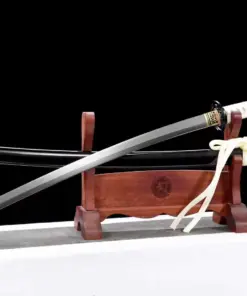 A Katana black and white sword saber, displayed next to its scabbard, on a small wooden stand.