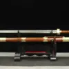 A two handed Ming Jian sword, displayed next to its scabbard, on a small wooden stand.