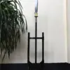 A spear stand holding a Chinese Guandao polearm.