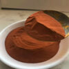 Ultra-fine copper powder displayed in a bowl and scoop.