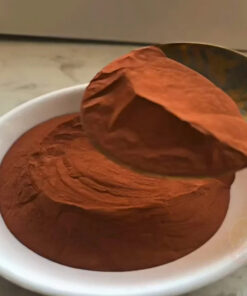 Ultra-fine copper powder displayed in a bowl and scoop.