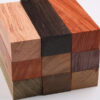 Nine species of exotic timber wood blocks, stacked in a neat pile.