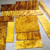 Multiple golden Nanmu wood blocks of differing sizes displayed.