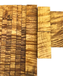 Multiple golden Nanmu wood blocks of differing sizes displayed.