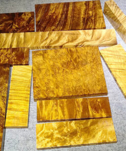 Multiple golden Nanmu wood blocks of differing sizes displayed.