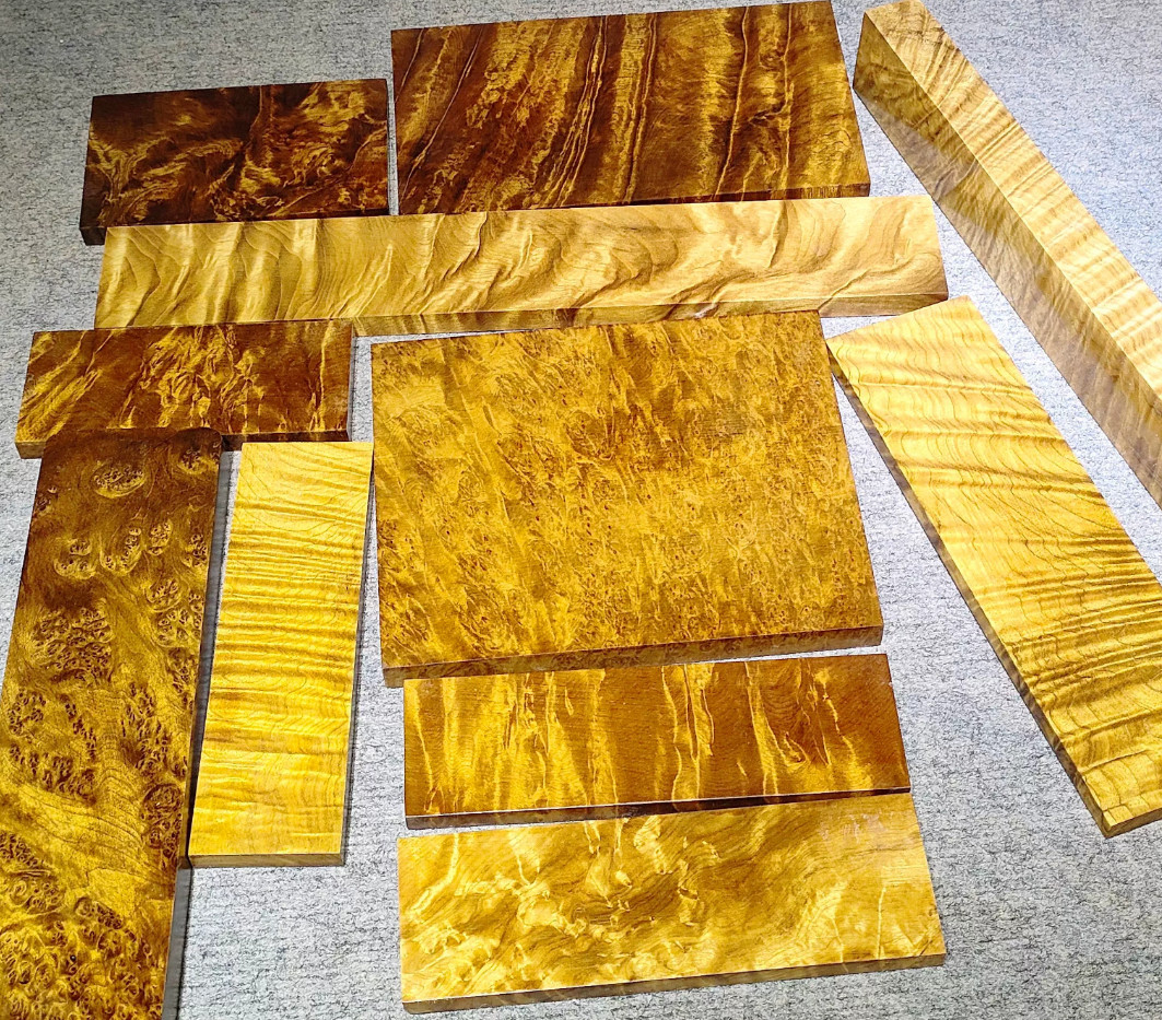 Golden Nanmu Wood Multiple golden Nanmu wood blocks of differing sizes displayed.