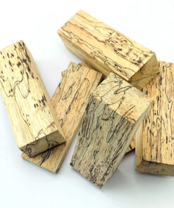 Multiple blocks of raw, white, spalted maple wood timber.