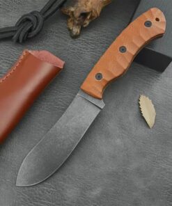 A skinning Nessmuk knife displayed next to its leather sheath.