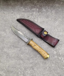 A Damascus hunting knife, displayed next to its leather sheath,