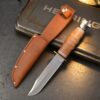 A deer hunting knife displayed nest to its leather sheath.