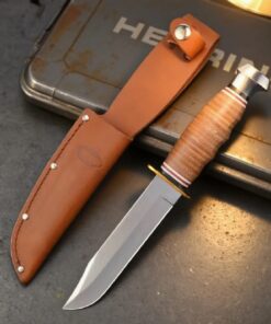 A deer hunting knife displayed nest to its leather sheath.