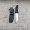 A full tang survival knife, displayed next to its Kydesx sheath.