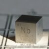 A pure nobium metal cube sample.