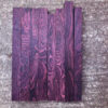 Multiple boards of purple rosewood wood blanks.