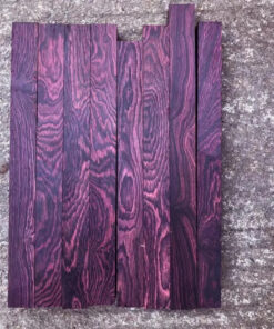 Multiple boards of purple rosewood wood blanks.