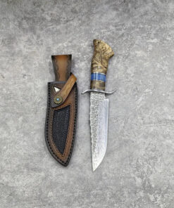 A survival knife with a Damascus steel fixed blade, displayed next to its leather sheath.