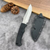 A fixed blade field knife, displayed next to its Kydex sheath.