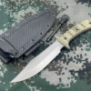 A fire starter knife, displayed next to its flint striker and Kydex sheath.