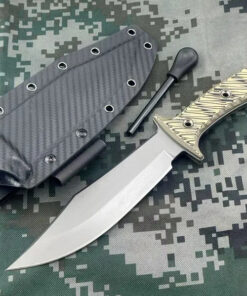 A fire starter knife, displayed next to its flint striker and Kydex sheath.