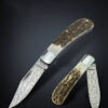 A horn handle pocket Damascus knife.