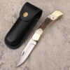 A folding lockback knife, displayed next to its leather knife pouch.