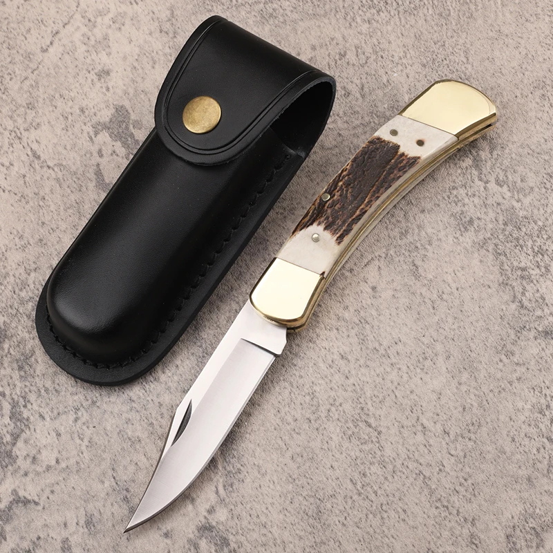 Lockback Knife A folding lockback knife, displayed next to its leather knife pouch.