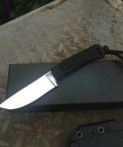 A paracord handle knife, displayed on a small black box.