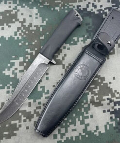 A Russian army knife displayed next to its sheath.