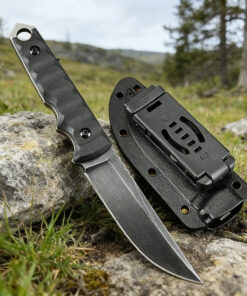 A sheath knife, displayed against a small rock, with a field background.