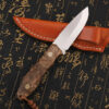 A bushcraft wooden handle knife, displayed against its leather knife sheath.