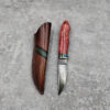 A deer caping wootz knife, displayed next to its sheath.