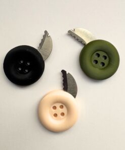 Three secret escape button knife models of differing color.
