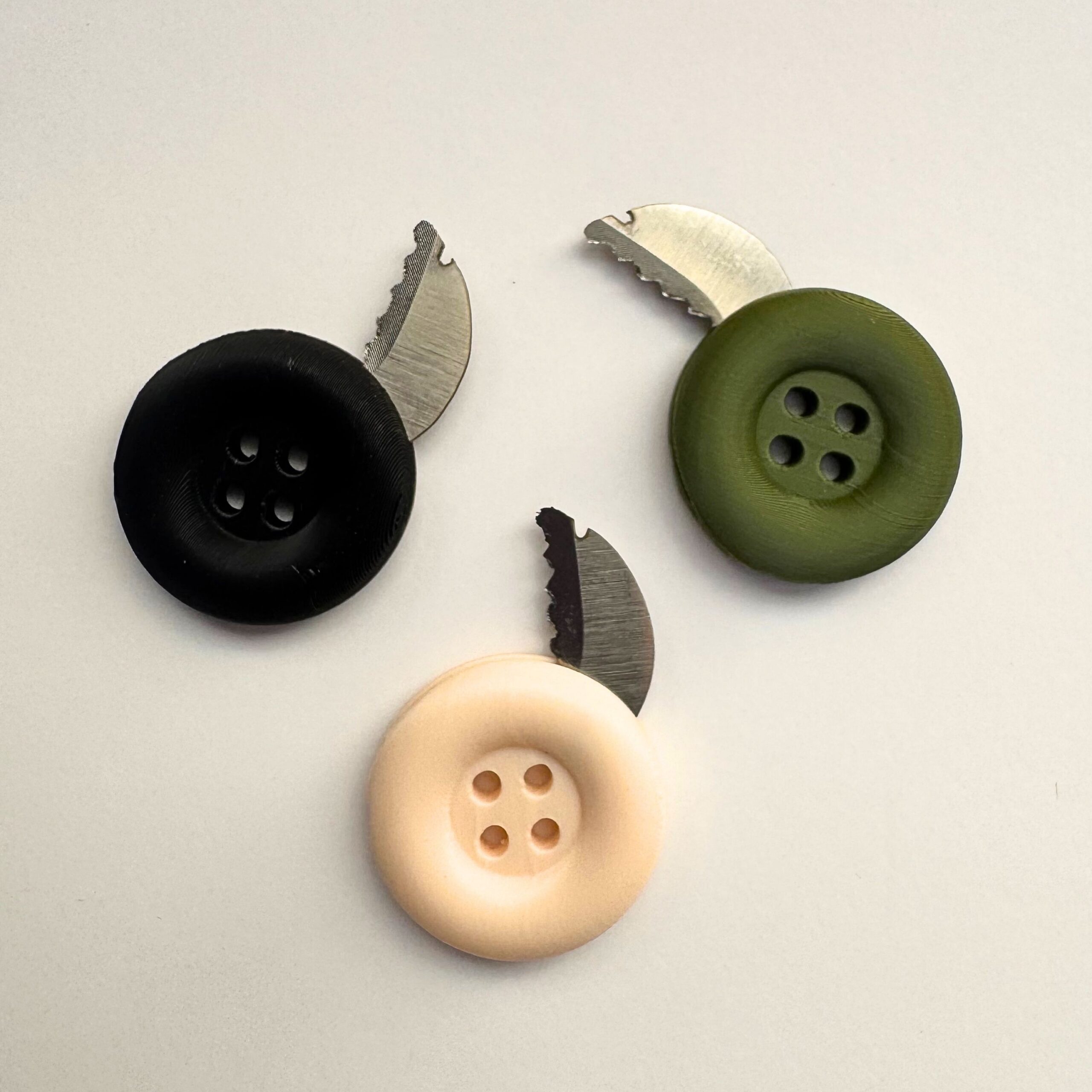 button-knife-10 Three secret escape button knife models of differing color.