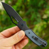 A hand holding an everyday carry pocket knife.
