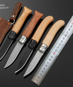 Four pocket knife with wooden handle models displayed next to a steel ruler.