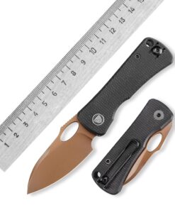 A small folding knife displayed next to a steel ruler.