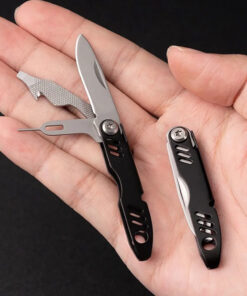 A man's hand holding a small travel knife.